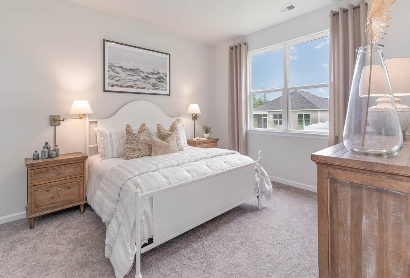 Carpeted bedroom featuring baseboards