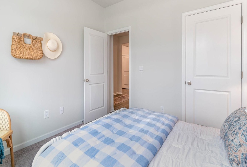 Carpeted bedroom with baseboards