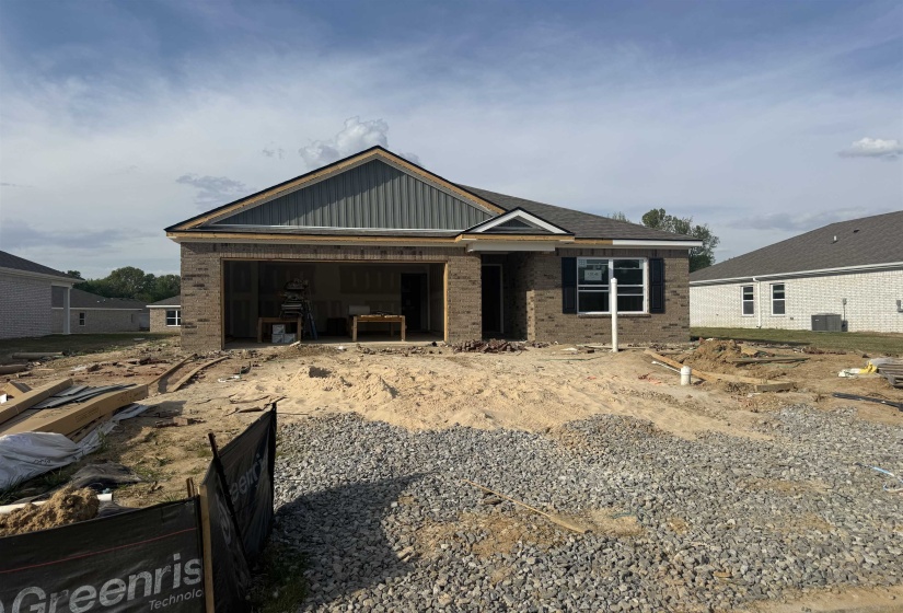 View of front facade featuring brick siding and a patio area