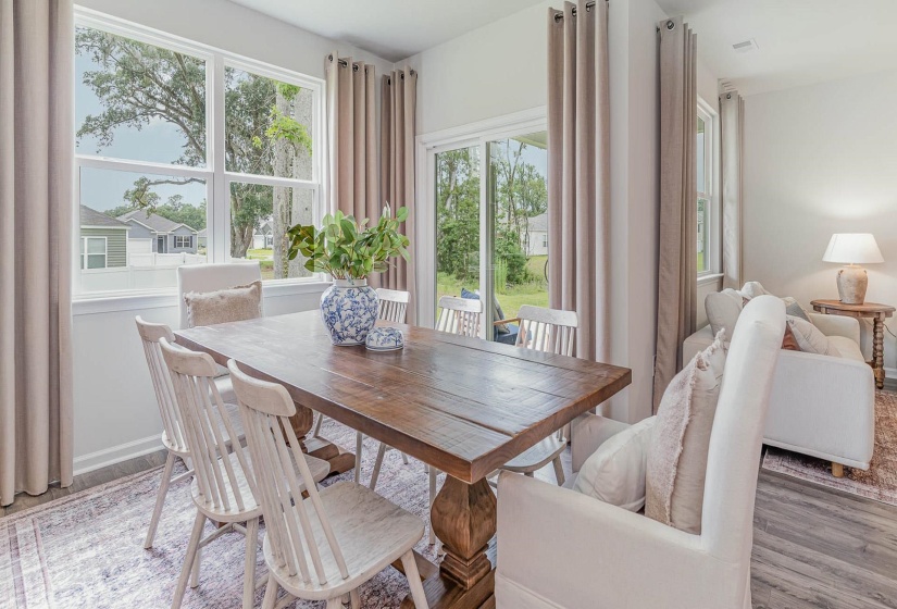 Dining room with healthy amount of natural light and light wood-style flooring