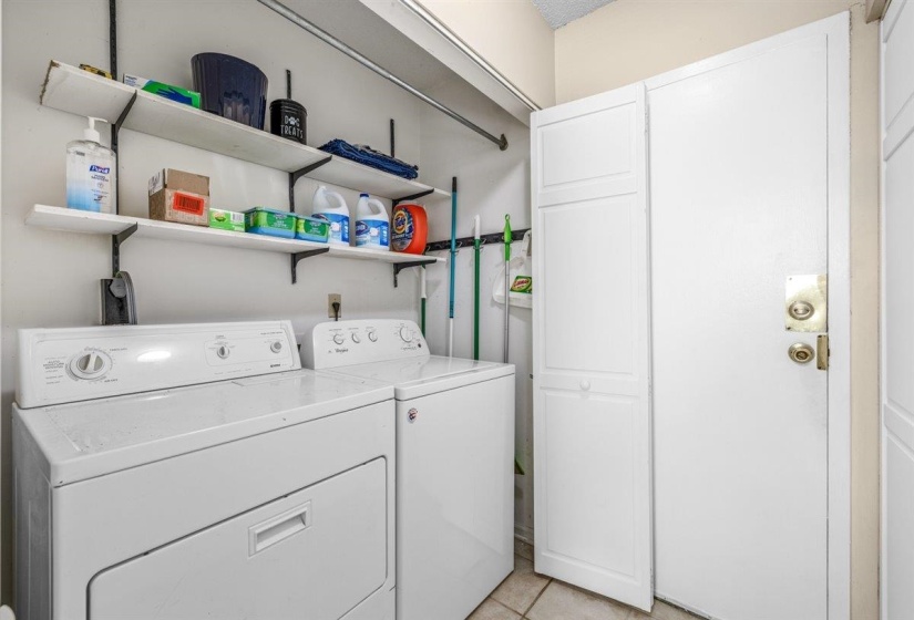 Dedicated laundry area featuring a white washing machine and dryer