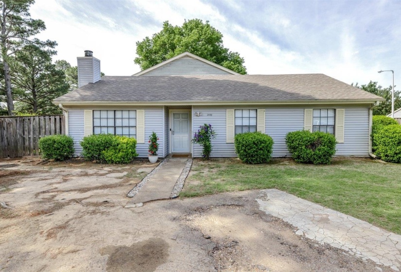 Single-story residence featuring light blue siding, a grey shingle roof, and a prominent chimney