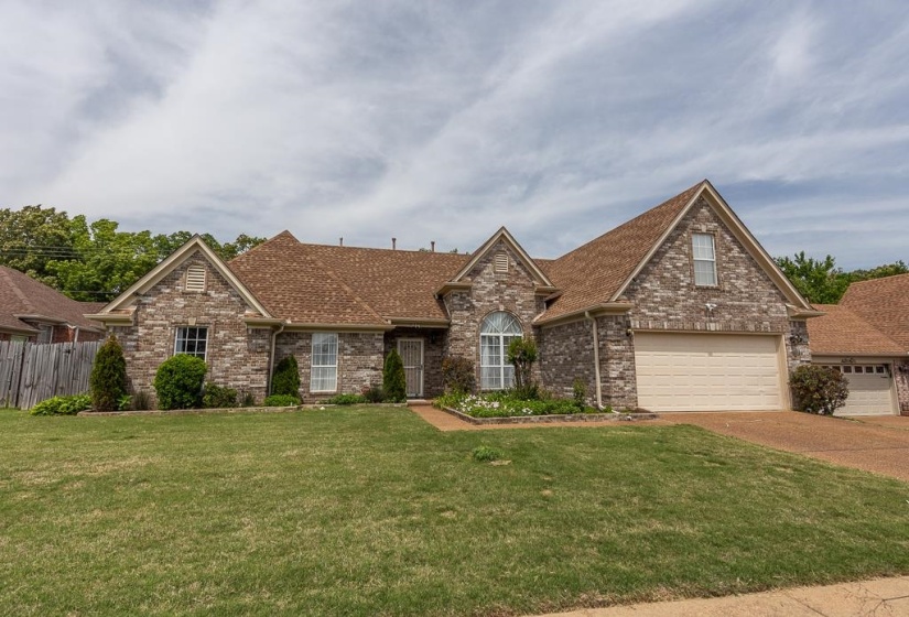 Front exterior with brick facade and multiple gables