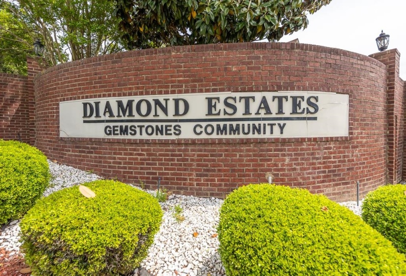 Brick entrance sign featuring white lettering for 