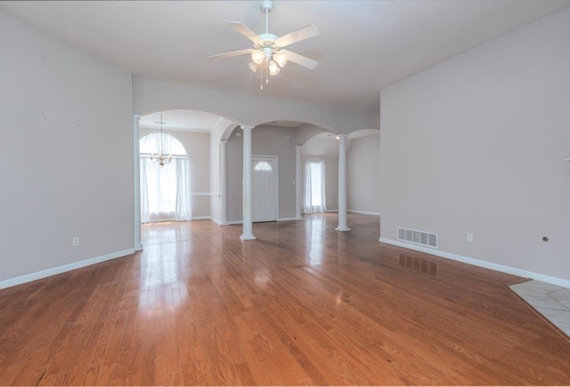 Hardwood-style flooring extends across an open concept living space