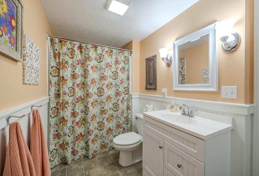 Bathroom featuring a white vanity with integrated sink, white-framed mirror, and chrome fixtures