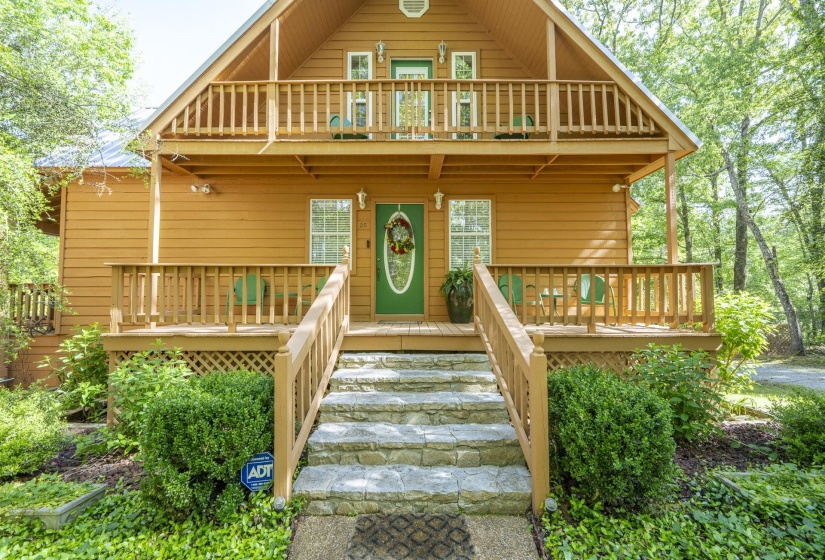 Exterior featuring wood siding, a prominent A-frame roofline, and multiple outdoor spaces