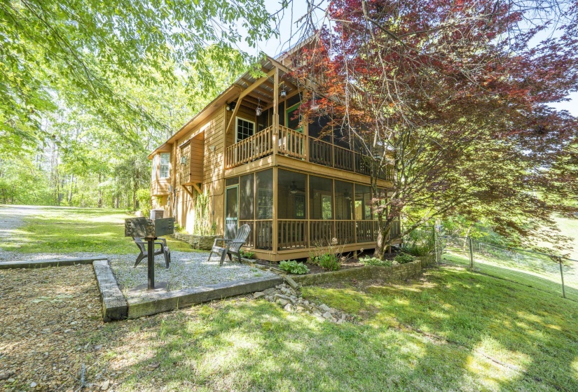 Wood-sided residence featuring a multi-level deck and screened porch