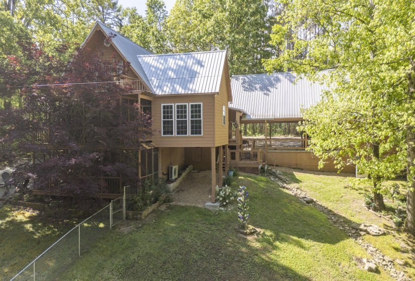 Expansive multi-level property with light brown siding and corrugated metal roofing