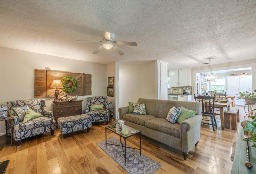 Hardwood flooring spanning the living and dining areas