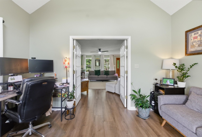 Room featuring vaulted ceilings and wood-finish flooring