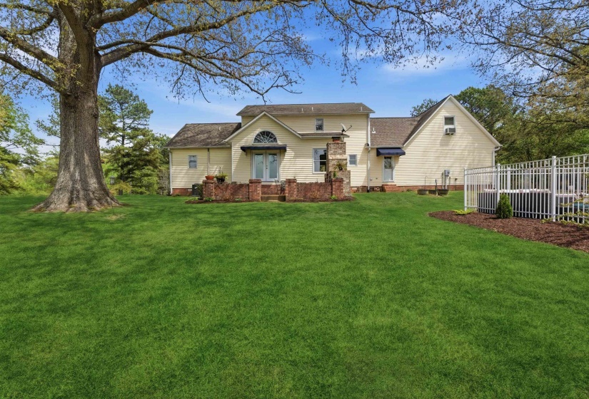 Expansive green lawn with mature trees