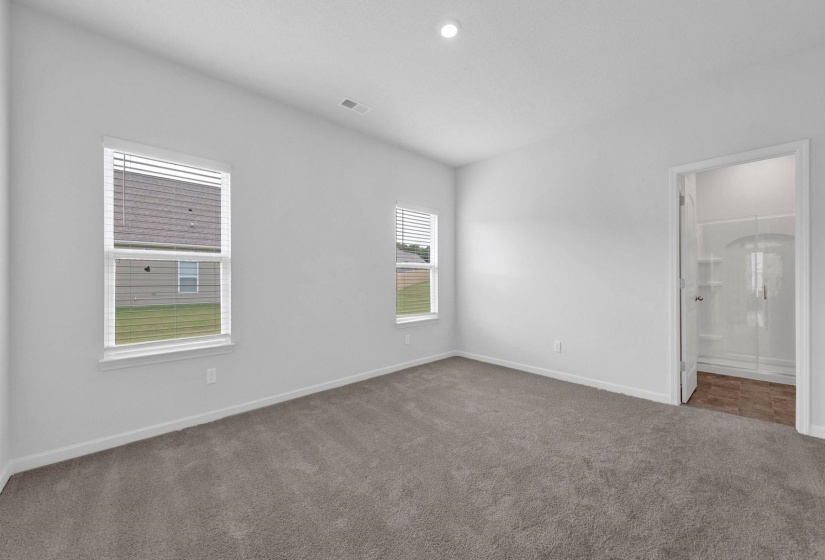 Carpeted room with white painted walls, two windows featuring blinds, and a recessed ceiling light
