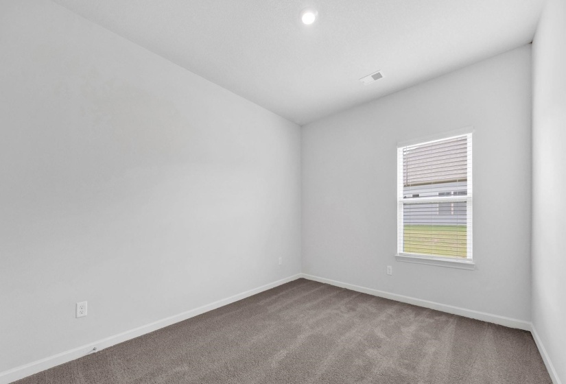 Room featuring neutral carpeting, white walls, and a single window with blinds