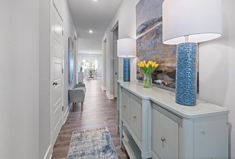 Entryway hall featuring wood-finish flooring, recessed lighting, and a console table