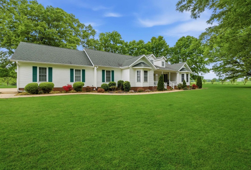 Expansive front lawn with mature perimeter trees