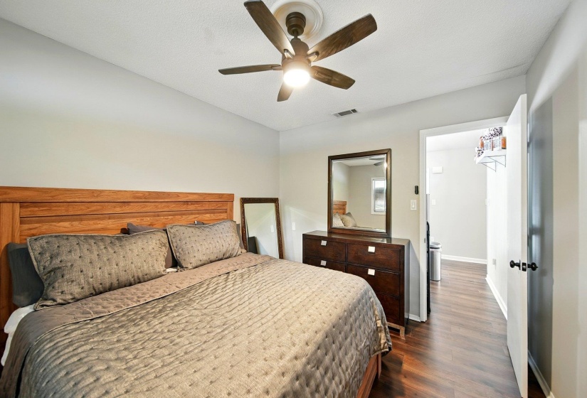 Bedroom with dark wood-style flooring and ceiling fan