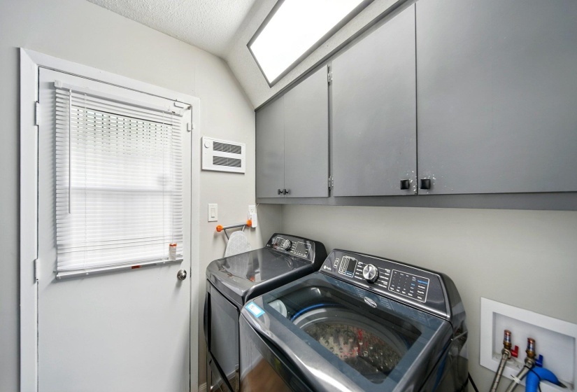 Laundry room with cabinet space and washing machine and dryer