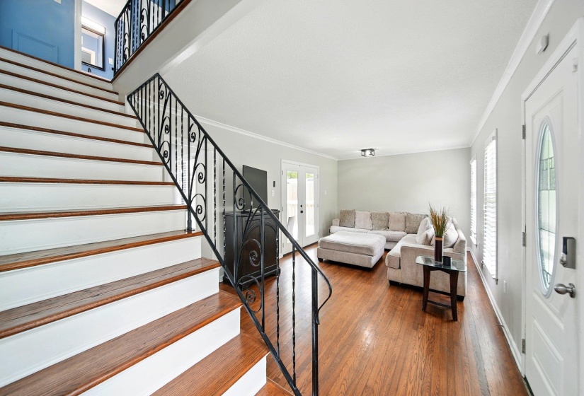 Living room featuring crown molding and dark wood finished floors