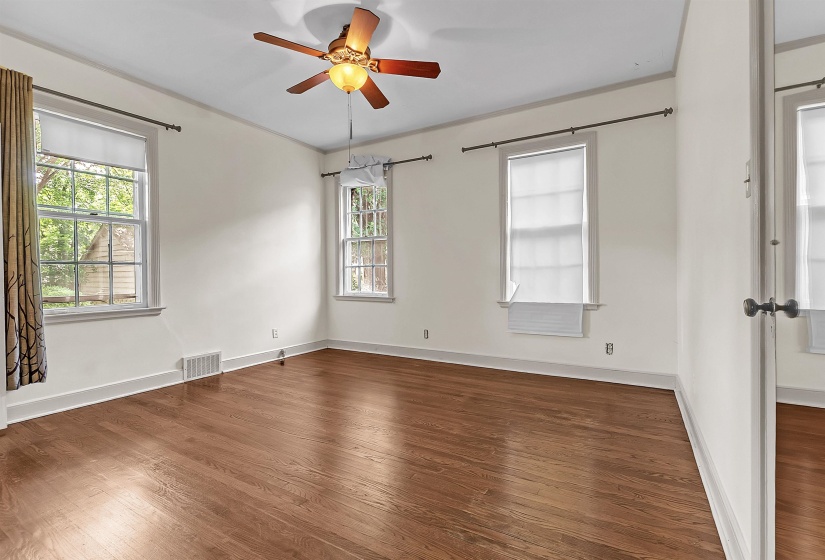 Interior room featuring wood-finish flooring, white walls, and white trim