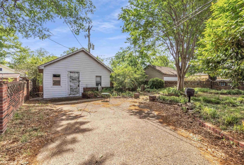 White detached structure with a pitched roof