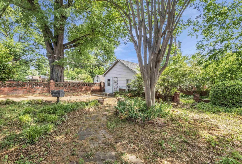 White-sided accessory building with a light-colored shingled roof