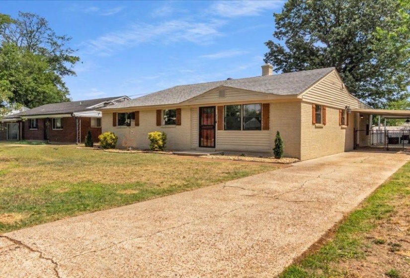 Single-story residence featuring light brick and horizontal siding