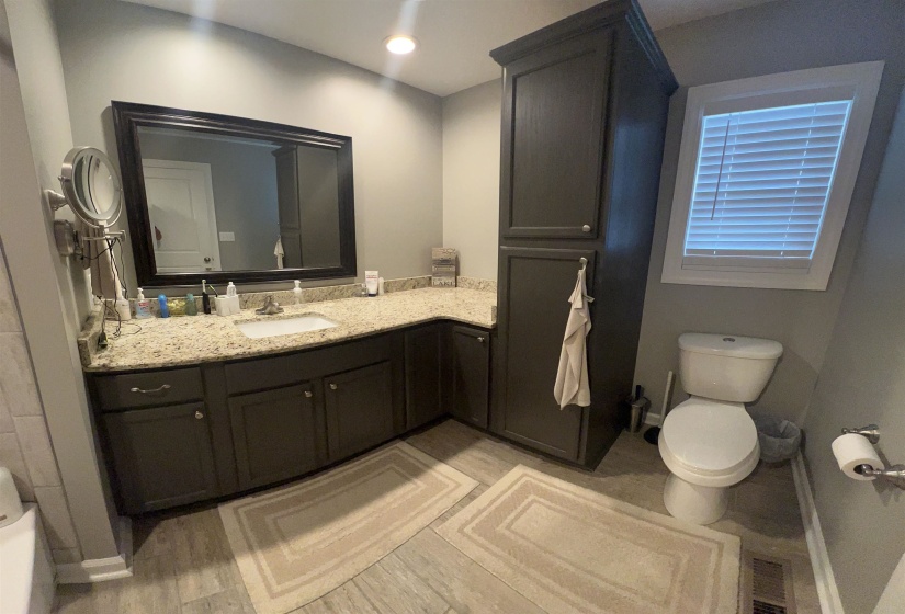 Bathroom with vanity, light wood-style floors, and recessed lighting