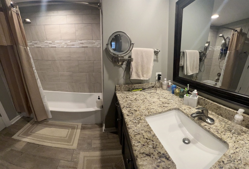 Bathroom with shower / bath combo and vanity