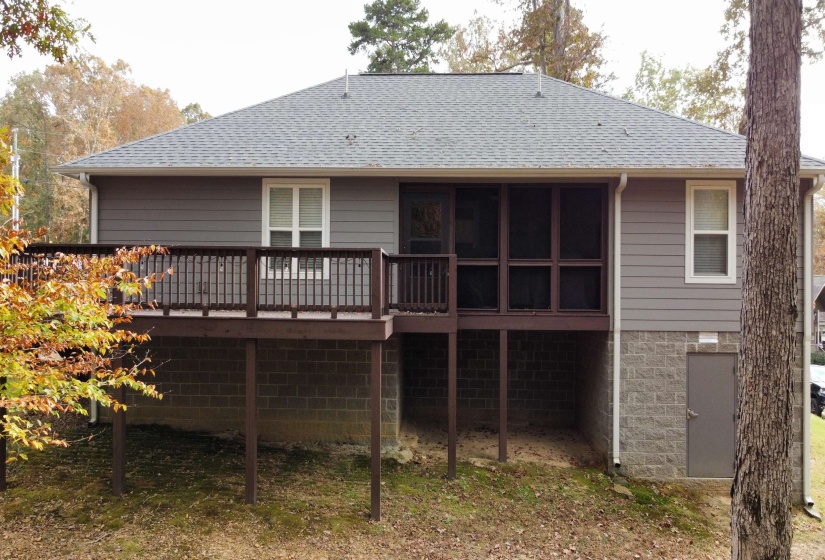 Rear view of property with a deck and a shingled roof
