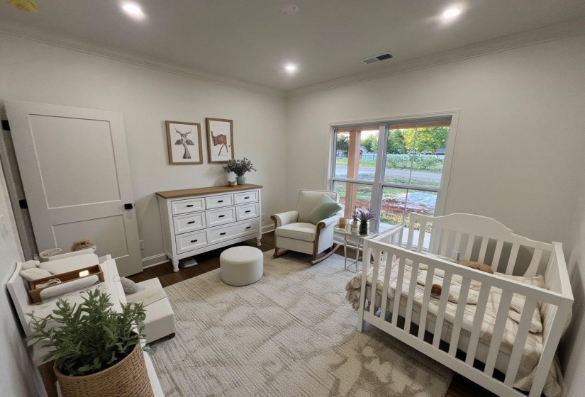 Room featuring crown molding, recessed lighting, and wood-finish flooring