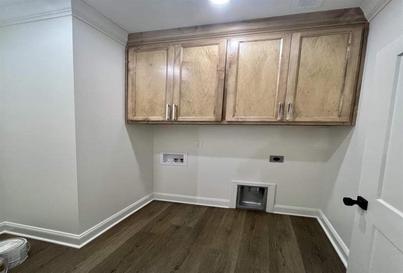 Laundry room with cabinet space, dark wood finished floors, hookup for an electric dryer, and hookup for a washing machine