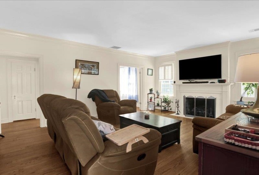 Spacious living area featuring the newly refurbished gas fireplace.