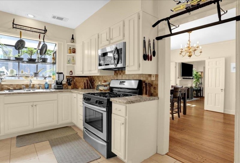 Kitchen with cream cabinetry, a stainless steel GAS range, and a built-in microwave.  NICE!