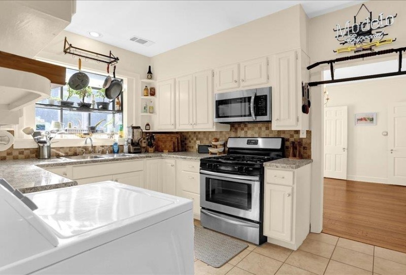 Nice the stone-finish countertops, stainless steel appliances, and a tiled backsplash.