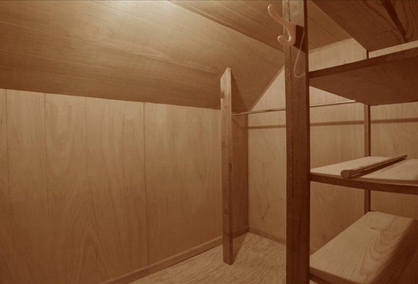 This storage room upstairs has built-in shelving, and clothes hanging rods.  Storage galore is right here!