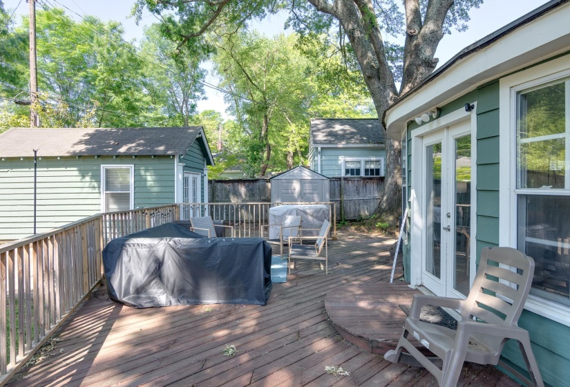 Expansive wood deck with a built-in curved section and wooden railing