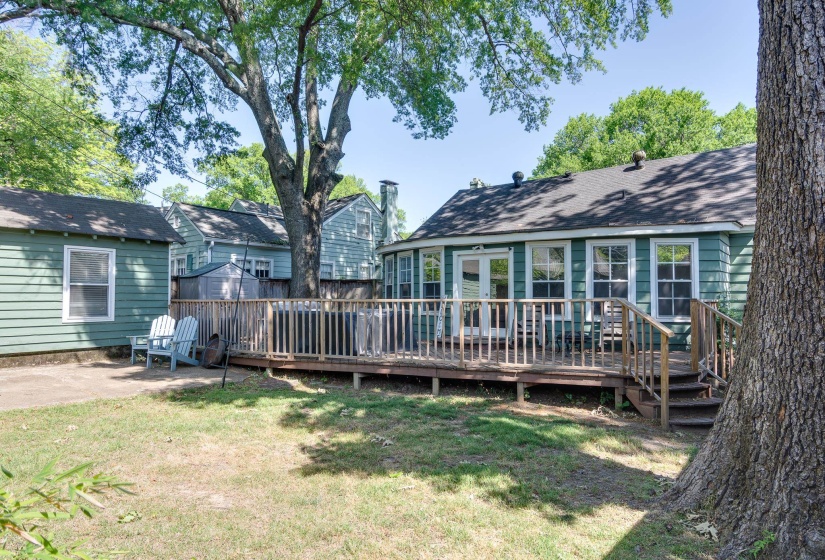 Rear exterior with wood deck and steps extending from the main structure