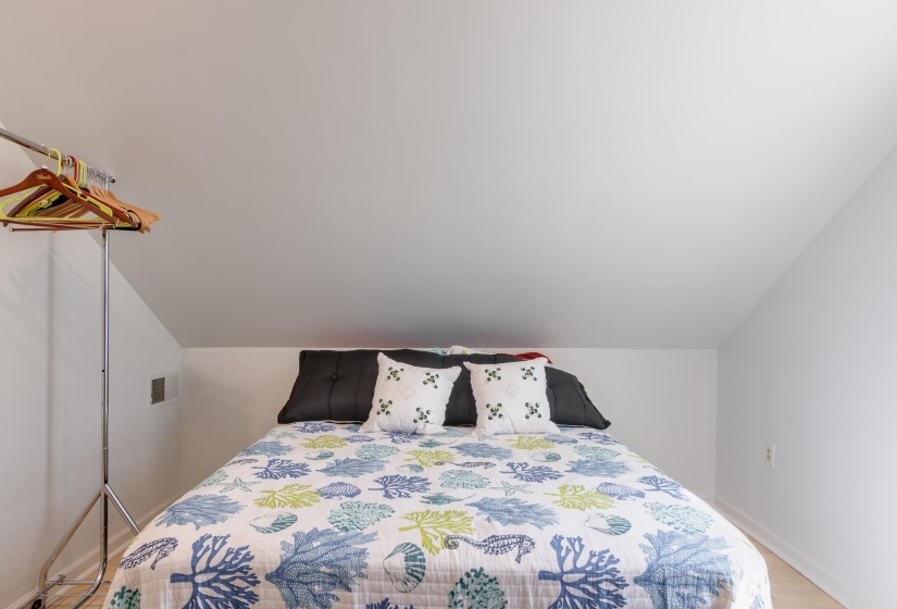 Attic room featuring a sloped ceiling and light-colored walls