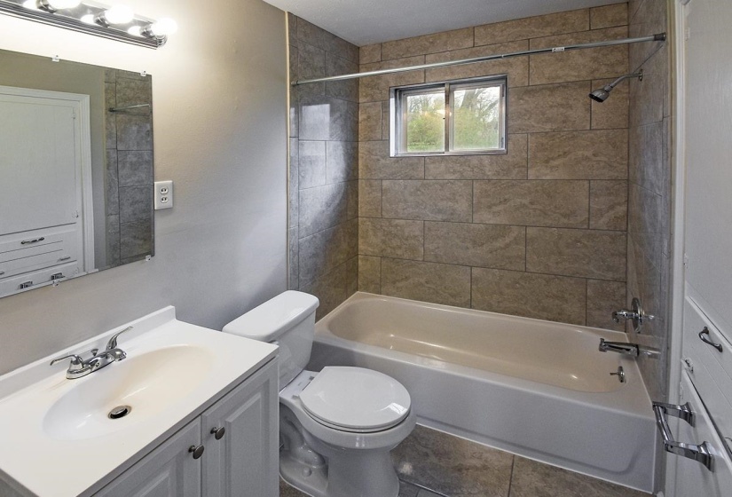 Full bath featuring shower / tub combination, vanity, and tile patterned floors