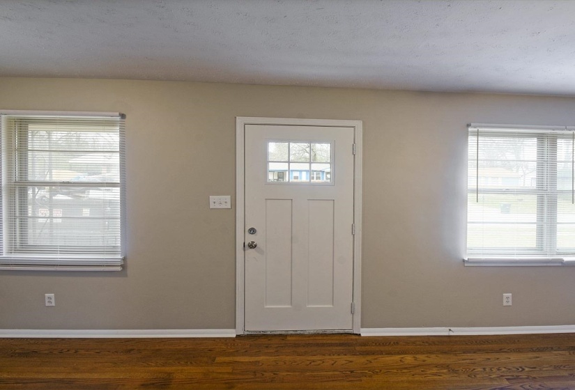 Entrance foyer featuring healthy amount of natural light and dark wood finished floors