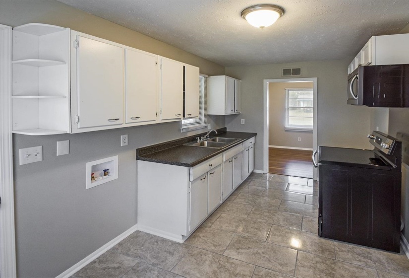 Kitchen with open shelves, black electric range oven, a textured ceiling, dark countertops, and white cabinetry