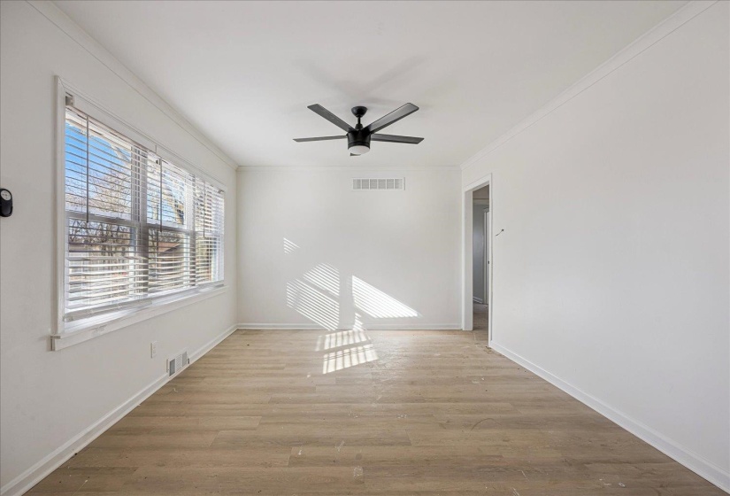 Bright room featuring wood-finish flooring and crisp white walls