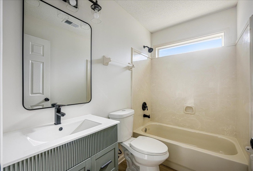 Modern bathroom featuring a single vanity with reeded paneling, a white countertop, and a rectangular undermount sink