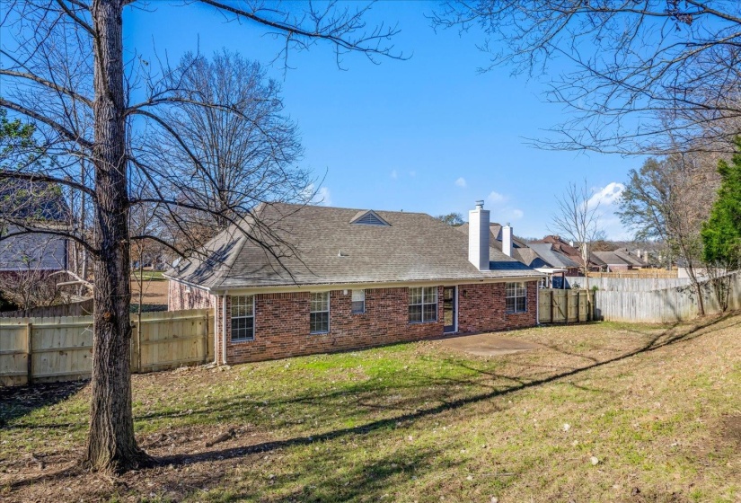 Brick exterior with a gray shingle roof and white chimney