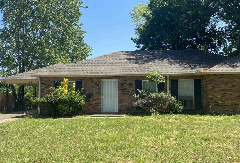 Brick exterior with a gabled roof and attached carport