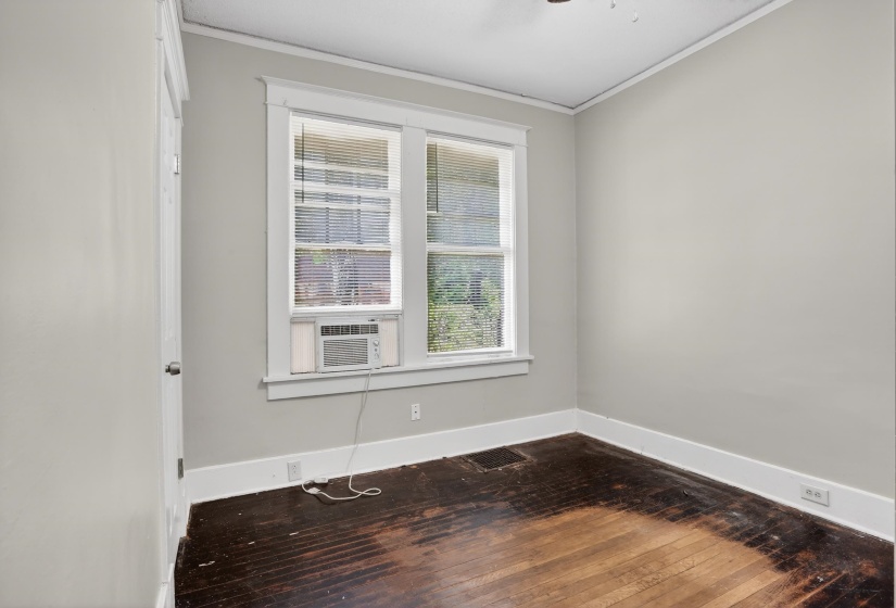 Interior room with light gray walls, white trim, and a window unit AC