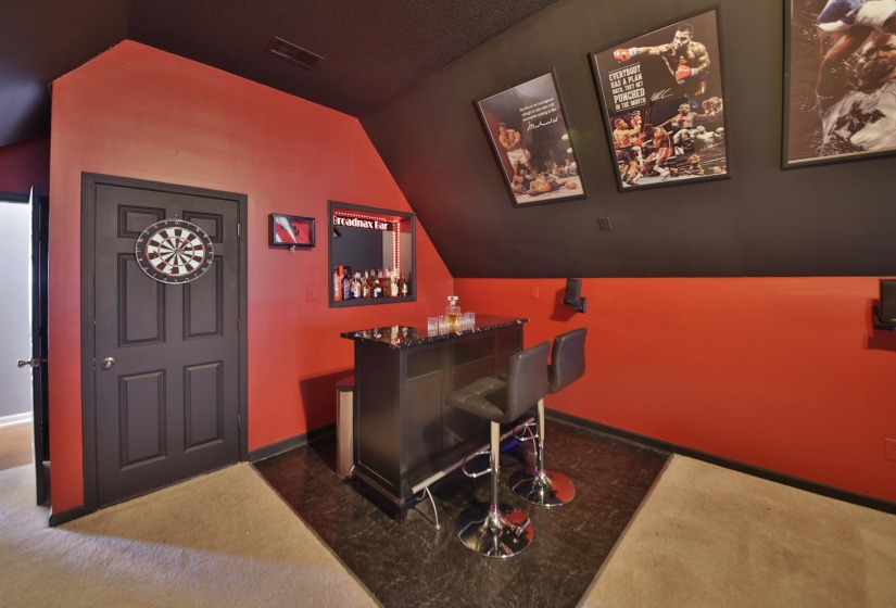 Built-in bar area featuring a dark countertop and integrated shelving