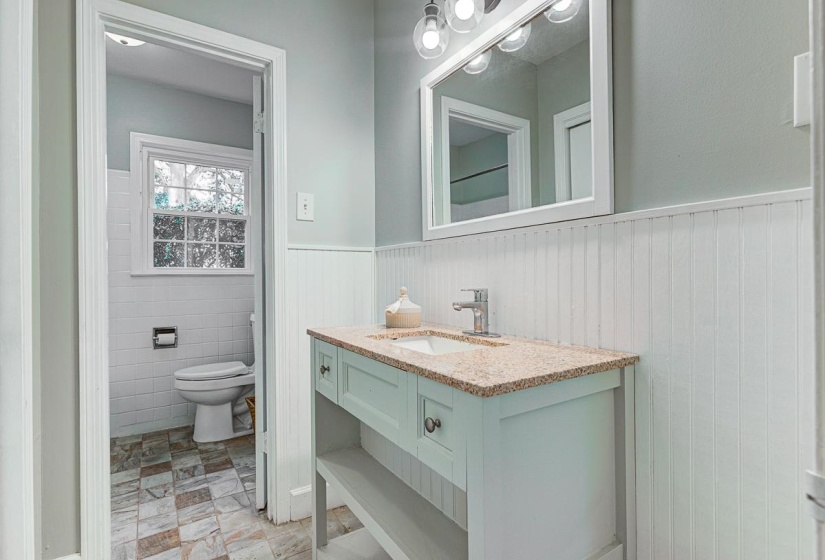 Bathroom vanity featuring a granite-style countertop, undermount sink, and chrome faucet, New vanity!