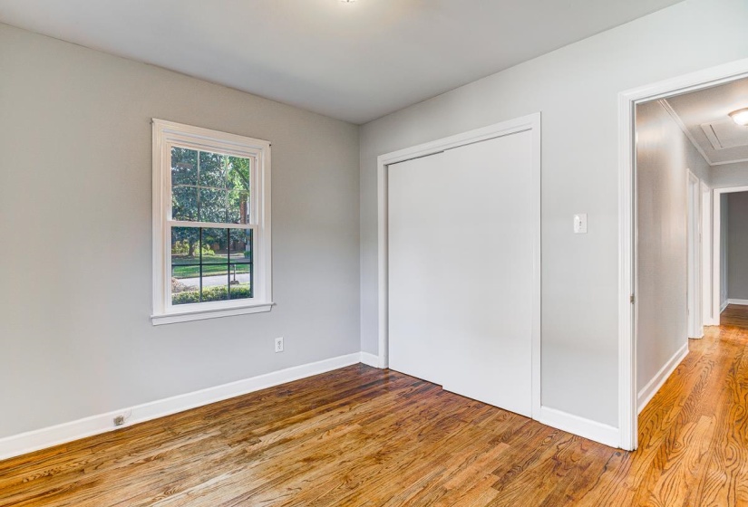 Light gray painted walls with white trim and wood-finish flooring